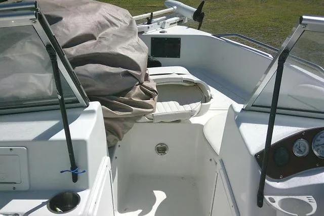 Slide: The Image of 2005 Sea Pro 195 Fish & Ski boat interior with covered seating and dashboard. - 11