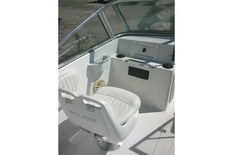 Slide: The Image of 2005 Sea Pro 195 Fish & Ski boat interior with white seating and dashboard. - 21