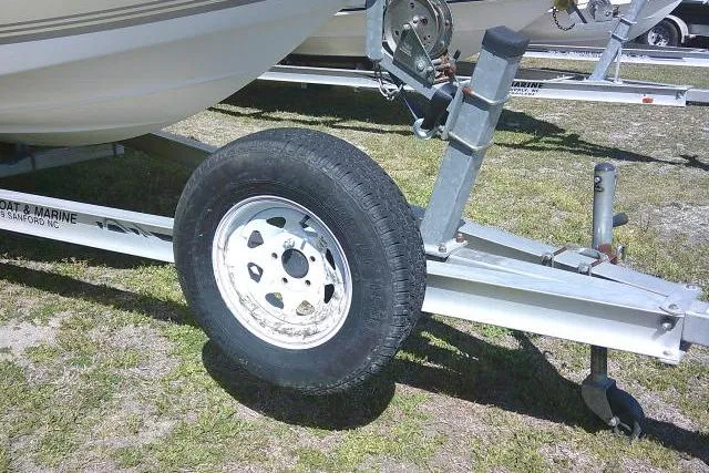 Slide: The Image of Trailer wheel of a 2005 Sea Pro 195 Fish & Ski boat on grass. - 3
