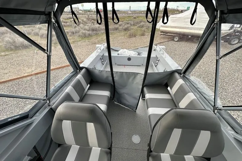 Slide: The Image of Interior view of 2026 Hewescraft 200 Sportsman boat with gray seating and canopy. - 8