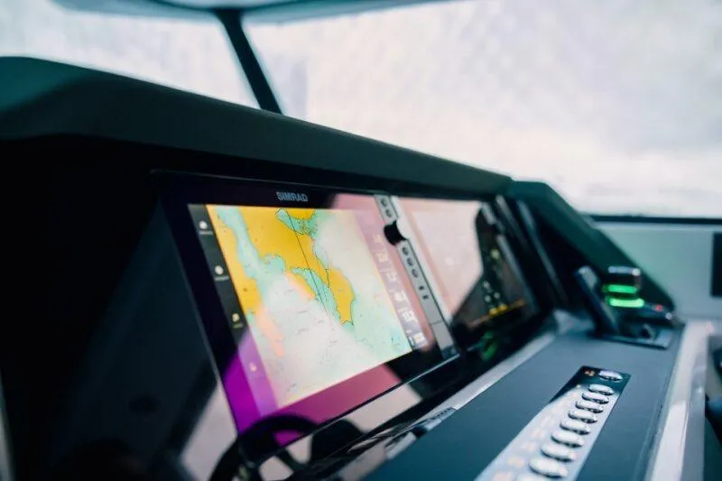 Slide: The Image of 2026 Axopar 38 Cross Cabin dashboard with advanced navigation display. - 10