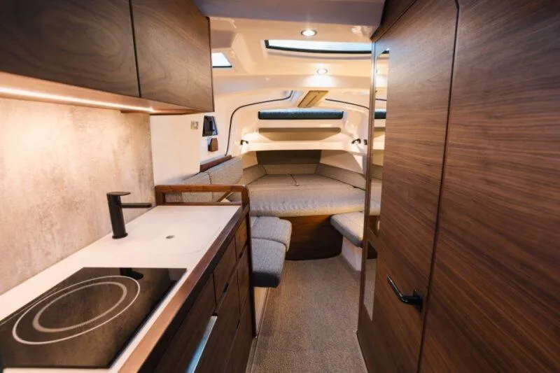 Slide: The Image of Luxurious interior of 2026 Axopar 38 Cross Cabin with modern kitchen and cozy seating area. - 20