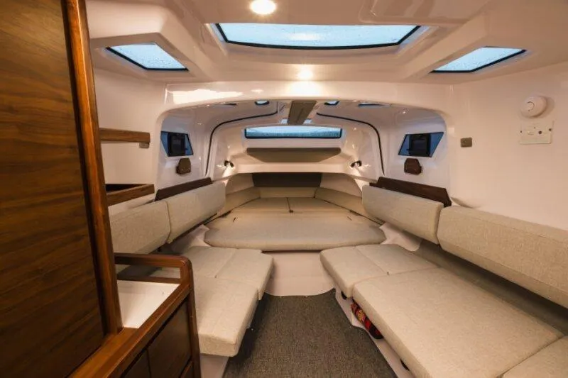Slide: The Image of Luxurious interior of 2026 Axopar 38 Cross Cabin with modern seating and skylights. - 22