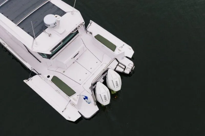 Slide: The Image of Aerial view of 2026 Axopar 38 Cross Cabin boat with twin outboard engines. - 9