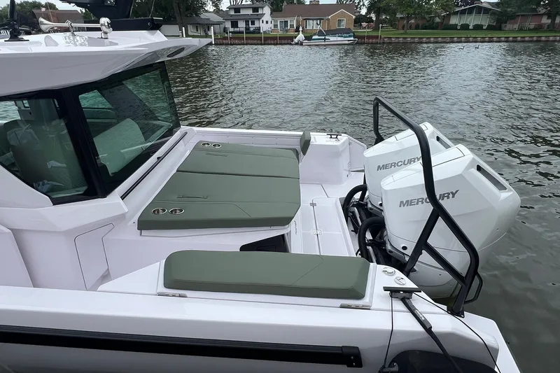 Slide: The Image of 2027 Axopar 38 Cross Cabin boat with Mercury engines on a calm river. - 4
