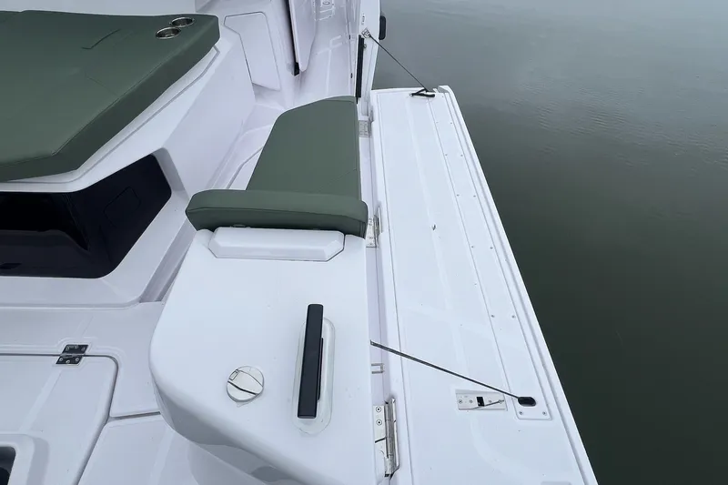 Slide: The Image of 2027 Axopar 38 Cross Cabin boat deck with green seating and sleek design. - 43
