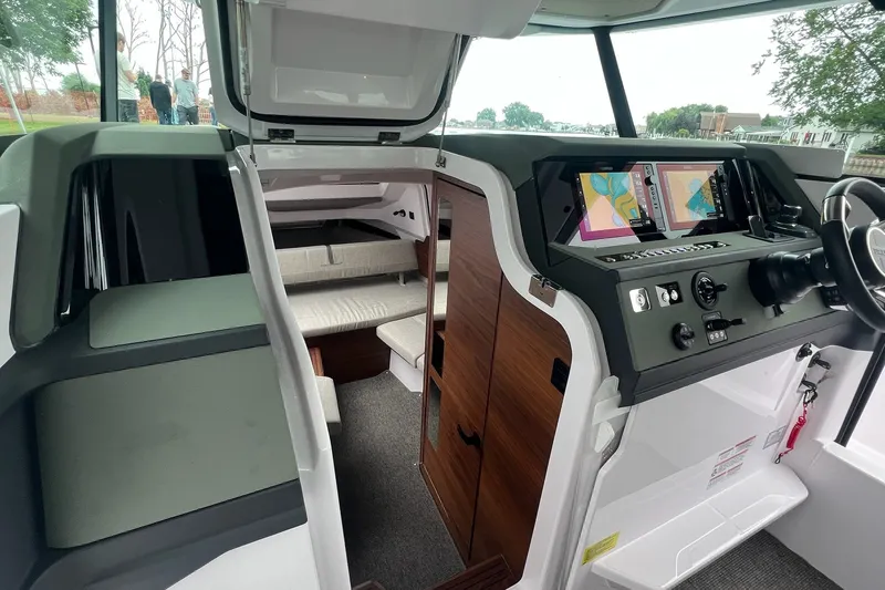 Slide: The Image of 2027 Axopar 38 Cross Cabin interior with navigation screens and seating area. - 16