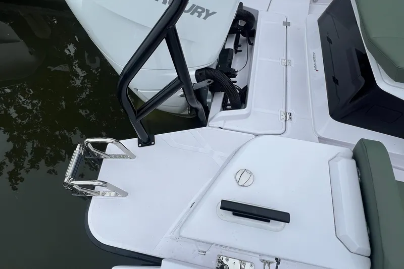 Slide: The Image of 2027 Axopar 38 Cross Cabin boat deck with Mercury engine and swim ladder. - 40