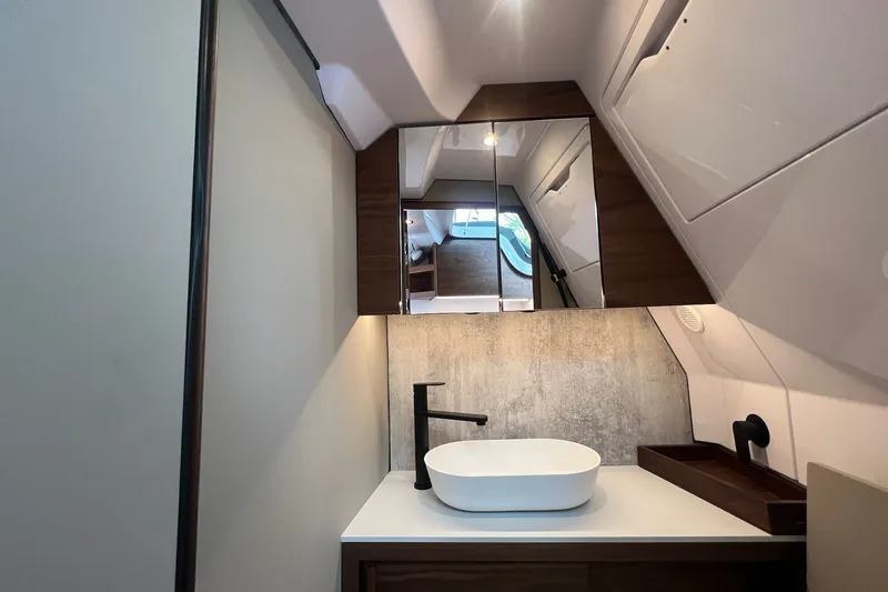Slide: The Image of Luxurious bathroom interior of 2027 Axopar 38 Cross Cabin with modern sink and mirror. - 29