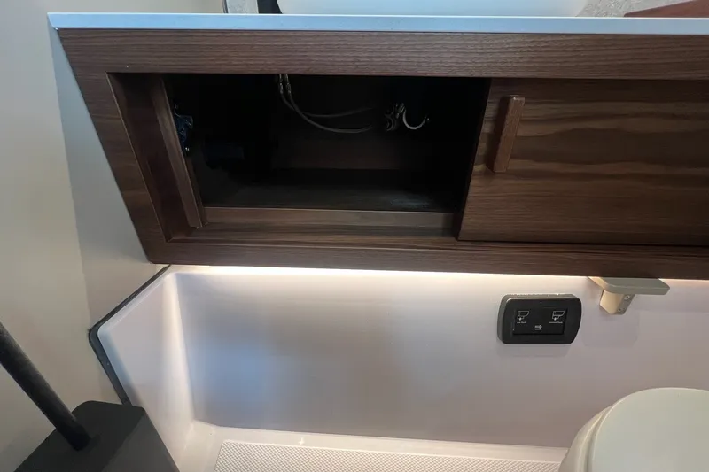 Slide: The Image of Interior of 2027 Axopar 38 Cross Cabin with wooden cabinet and control panel. - 31