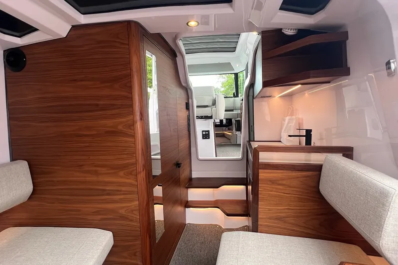 Slide: The Image of Interior of 2027 Axopar 38 Cross Cabin with modern wood finish and seating. - 27