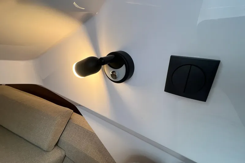 Slide: The Image of Wall-mounted light and switch in 2027 Axopar 38 Cross Cabin interior. - 26