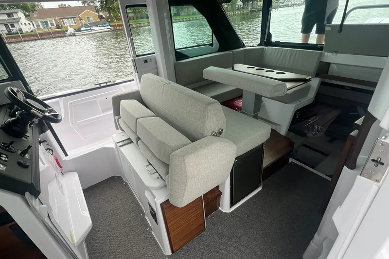Slide: The Image of Interior of 2027 Axopar 38 Cross Cabin boat with seating and steering area. - 7