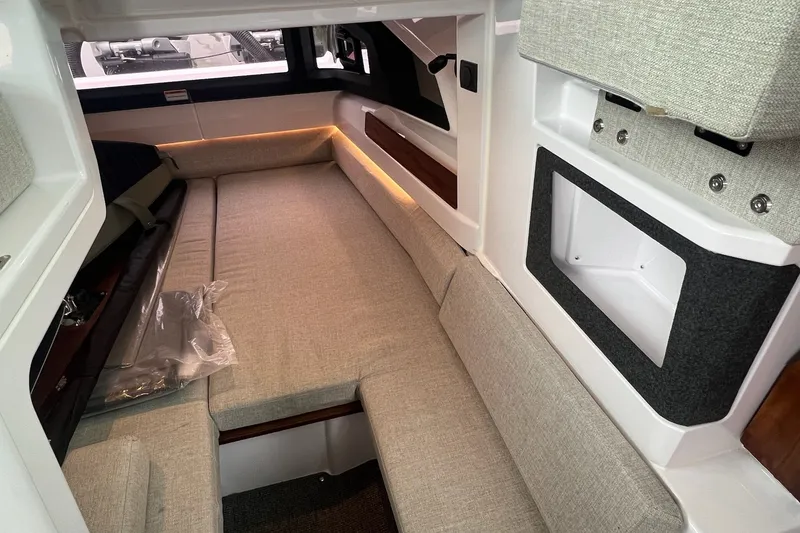 Slide: The Image of Interior of 2027 Axopar 38 Cross Cabin with beige seating and modern design. - 10