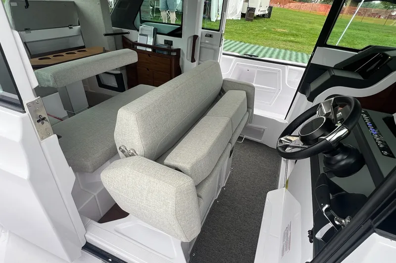 Slide: The Image of 2027 Axopar 38 Cross Cabin interior with modern seating and steering wheel. - 36