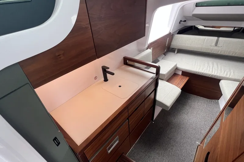Slide: The Image of Modern interior of 2027 Axopar 38 Cross Cabin with sleek kitchen and seating area. - 21