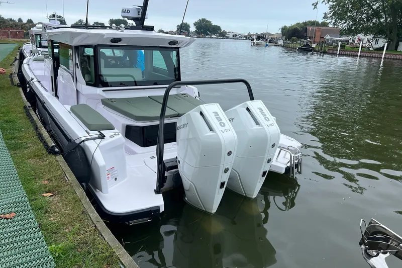 Slide: The Image of 2027 Axopar 38 Cross Cabin boat docked with twin Mercury V10 engines. - 48