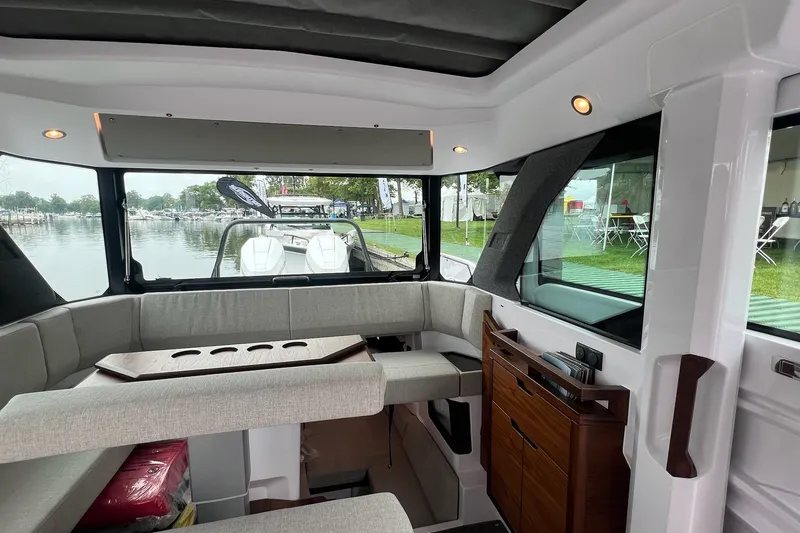 Slide: The Image of Interior of 2027 Axopar 38 Cross Cabin boat with modern seating and waterfront view. - 12
