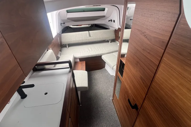 Slide: The Image of Interior of 2027 Axopar 38 Cross Cabin with modern wood finish and cozy seating. - 8