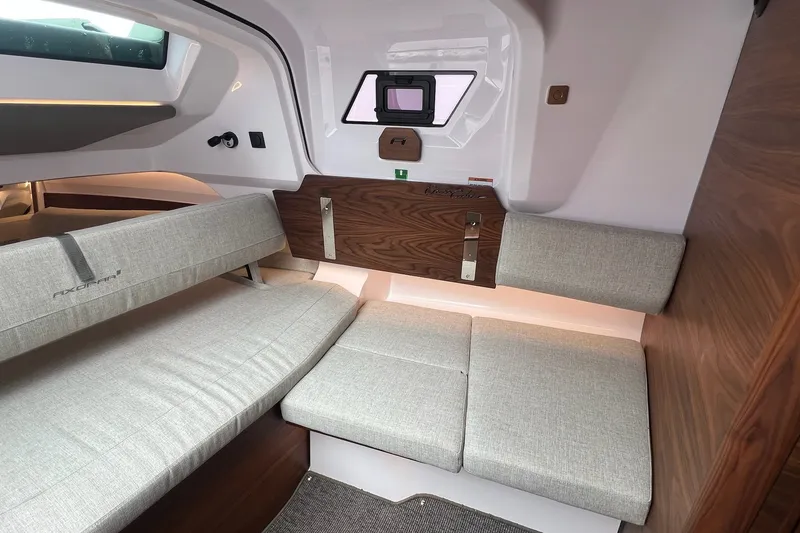 Slide: The Image of Interior of 2027 Axopar 38 Cross Cabin with modern seating and wood accents. - 25