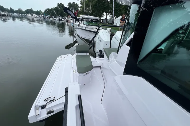 Slide: The Image of 2027 Axopar 38 Cross Cabin boat docked, featuring sleek design and modern seating. - 38