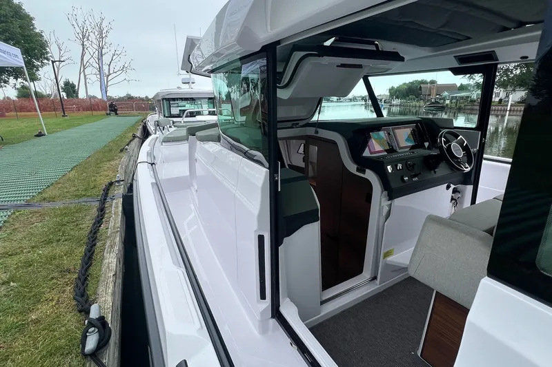 Slide: The Image of 2027 Axopar 38 Cross Cabin boat interior with modern dashboard and seating. - 33