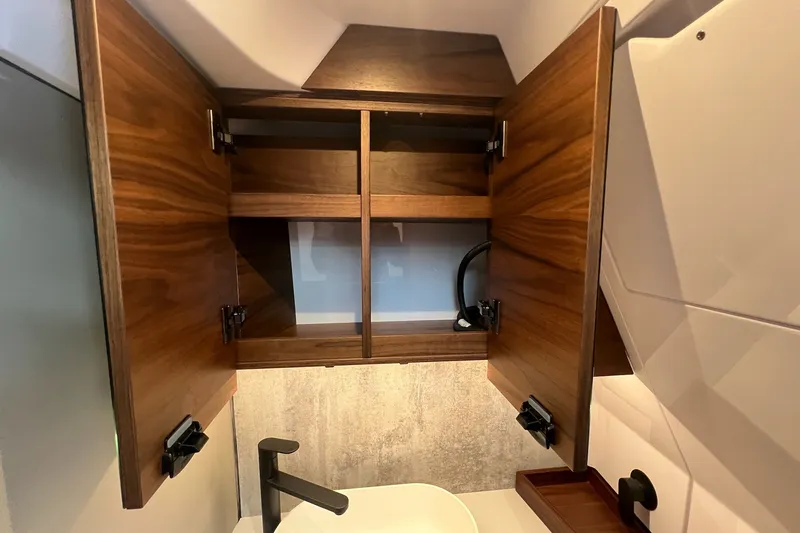 Slide: The Image of Wooden cabinet and sink in 2027 Axopar 38 Cross Cabin boat interior. - 30