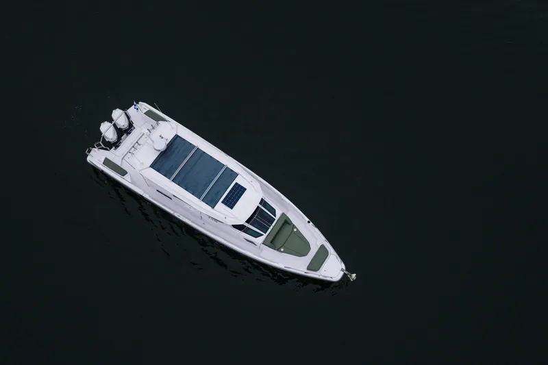 Slide: The Image of Aerial view of 2026 Axopar 38 Cross Cabin boat on dark water. - 4