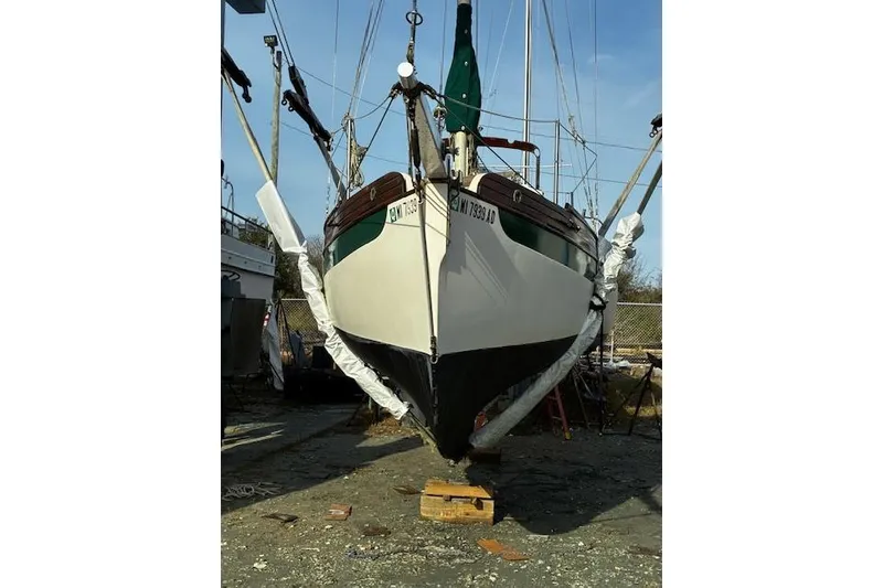 Slide: The Image of 1982 Falmouth Cutter 22 sailboat on dry dock, ready for maintenance. - 10