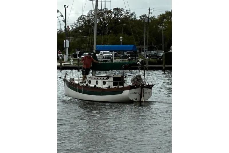 Slide: The Image of 1982 Falmouth Cutter 22 sailboat on water, dockside view. - 13