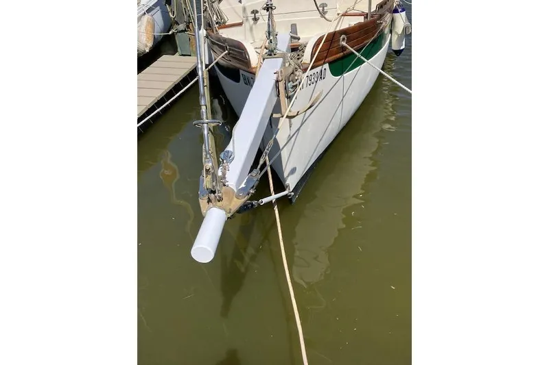 Slide: The Image of 1982 Falmouth Cutter 22 docked, showcasing its bow and anchor setup. - 17