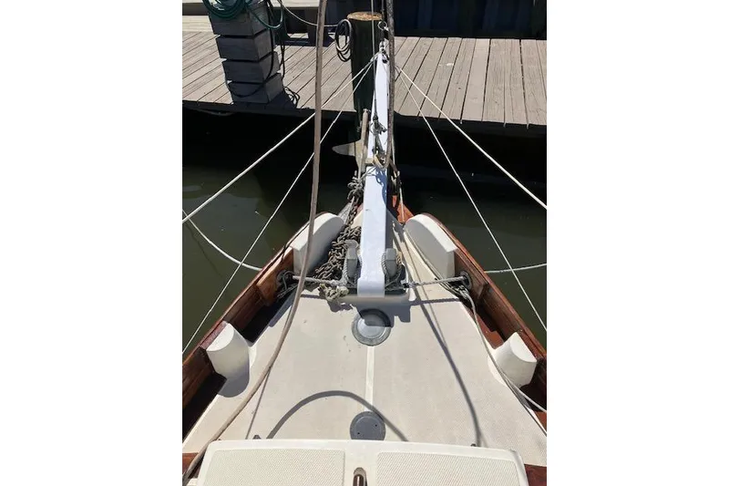 Slide: The Image of Bow view of a 1982 Falmouth Cutter 22 sailboat docked at a marina. - 20