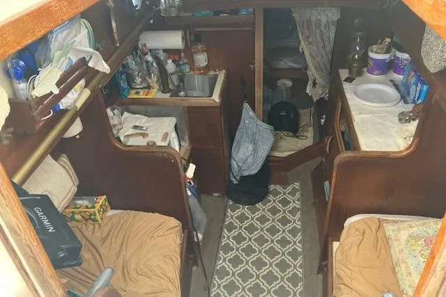 Slide: The Image of Interior of a 1982 Falmouth Cutter 22 sailboat, featuring a compact cabin layout. - 22