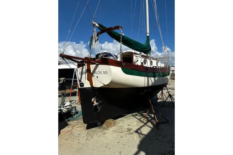 Slide: The Image of 1982 Falmouth Cutter 22 sailboat on dry dock, Biloxi, MS, with green sail cover. - 3