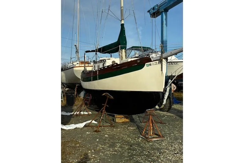 Slide: The Image of 1982 Falmouth Cutter 22 sailboat on dry dock, ready for maintenance. - 6