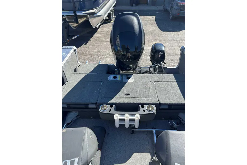 Slide: The Image of 2015 Lund 1900 Tyee boat interior with motor and seating area. - 10