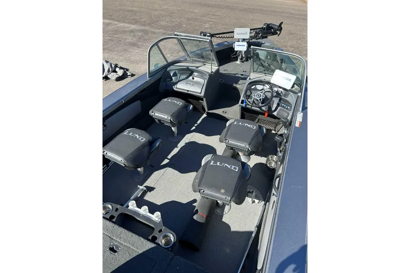 Slide: The Image of 2015 Lund 1900 Tyee boat interior with seating and steering console. - 11