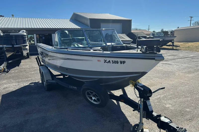 Slide: The Image of 2015 Lund 1900 Tyee boat on trailer in outdoor dealership lot. - 4