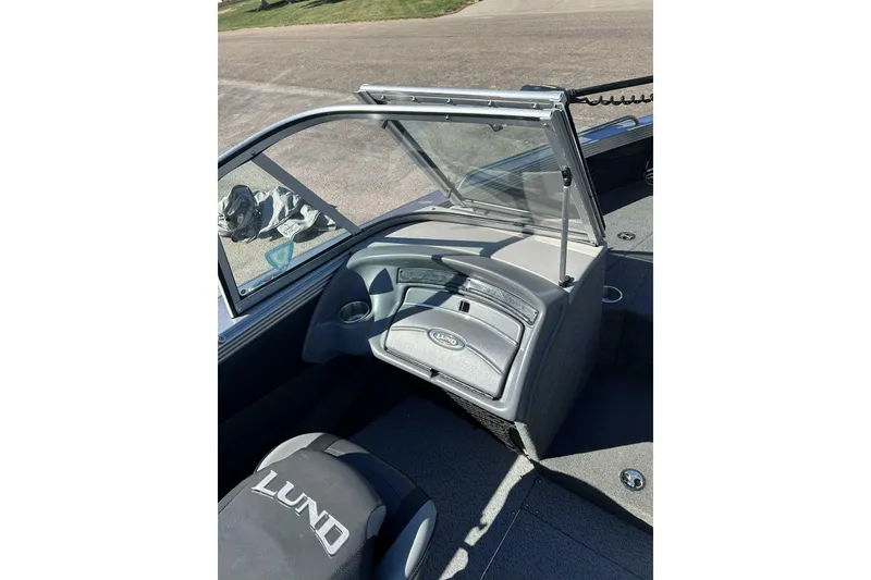 Slide: The Image of 2015 Lund 1900 Tyee boat interior with windshield and seating. - 8