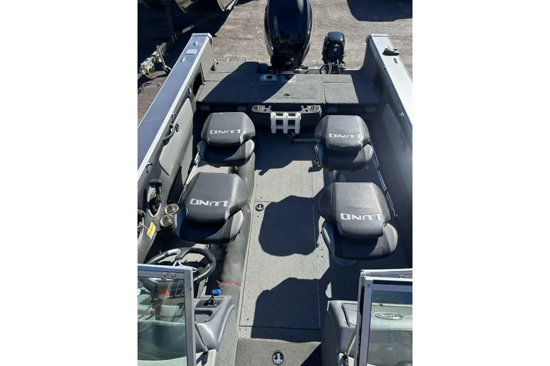 Slide: The Image of 2015 Lund 1900 Tyee boat interior with seating and steering wheel. - 9