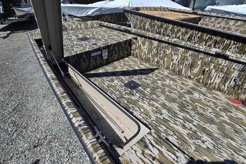 Slide: The Image of 2025 Avid 16 Commander boat with camouflage interior design, featuring storage compartments. - 11