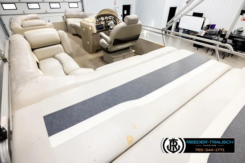 Slide: The Image of 2004 Smoker Craft 820 Infinity Cruise boat interior with beige seating and control panel. - 11