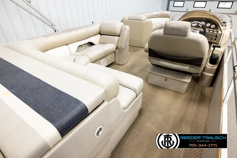 Slide: The Image of 2004 Smoker Craft 820 Infinity Cruise boat interior with beige seating and control panel. - 12