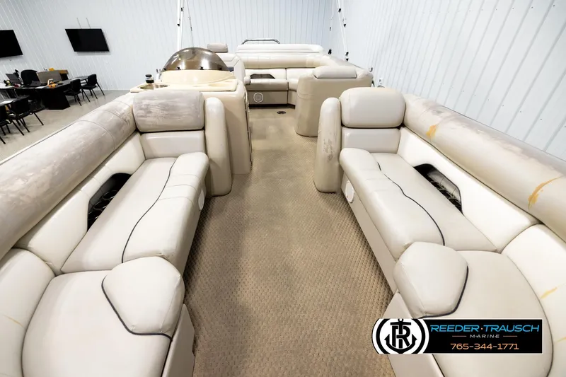 Slide: The Image of 2004 Smoker Craft 820 Infinity Cruise pontoon boat interior with beige seating and carpet. - 13