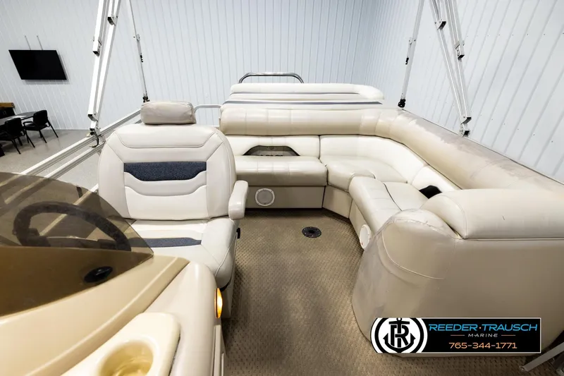 Slide: The Image of 2004 Smoker Craft 820 Infinity Cruise boat interior with beige seating and steering console. - 14