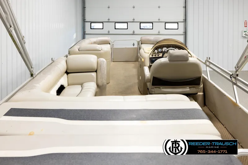 Slide: The Image of 2004 Smoker Craft 820 Infinity Cruise boat interior with beige seating and steering console. - 16