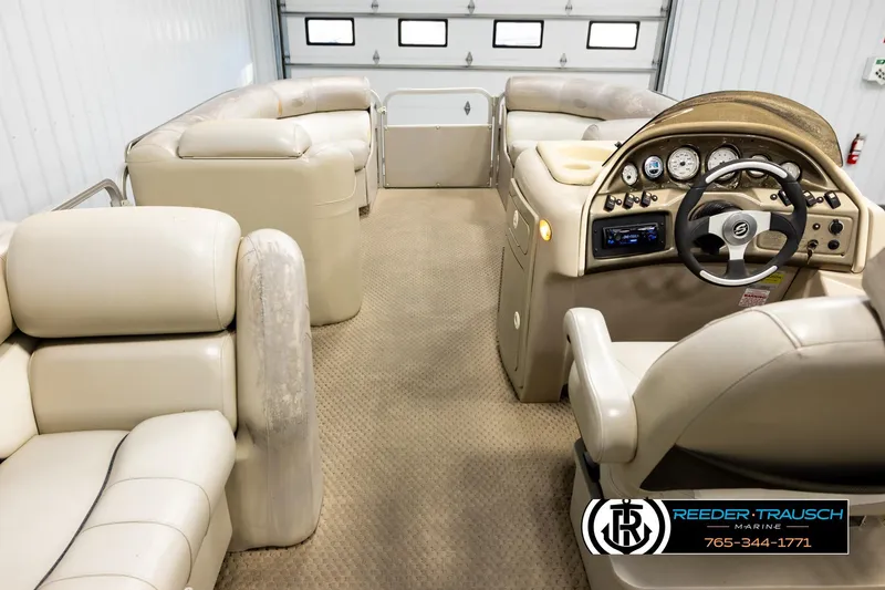Slide: The Image of 2004 Smoker Craft 820 Infinity Cruise boat interior with beige seating and control panel. - 17
