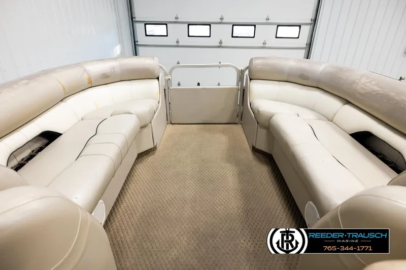 Slide: The Image of 2004 Smoker Craft 820 Infinity Cruise boat interior with beige seating in a garage. - 18