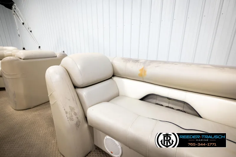 Slide: The Image of 2004 Smoker Craft 820 Infinity Cruise boat interior with beige seating and visible wear. - 20