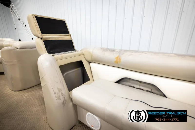 Slide: The Image of 2004 Smoker Craft 820 Infinity Cruise boat interior with beige seating and storage compartment. - 21